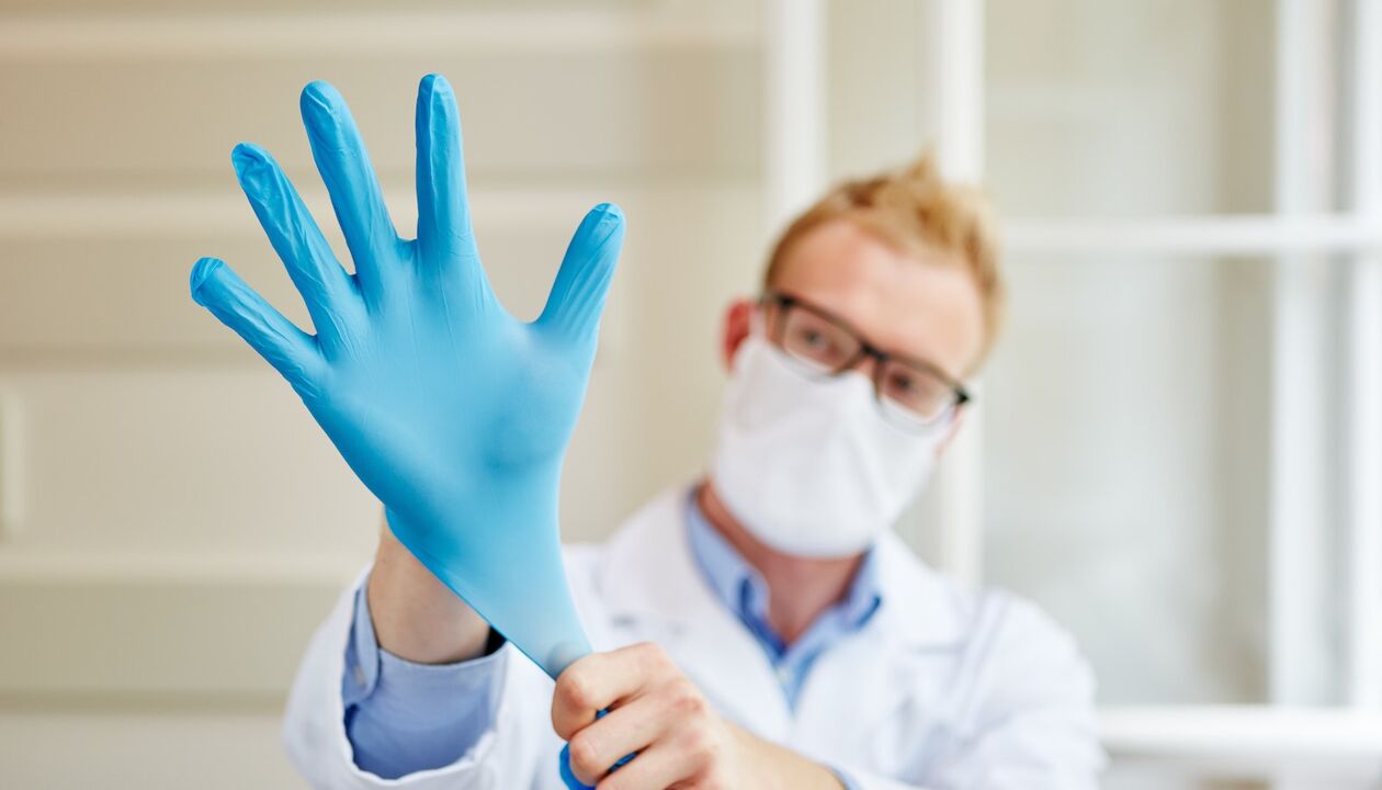 the doctor puts on gloves for massage to prevent prostatitis